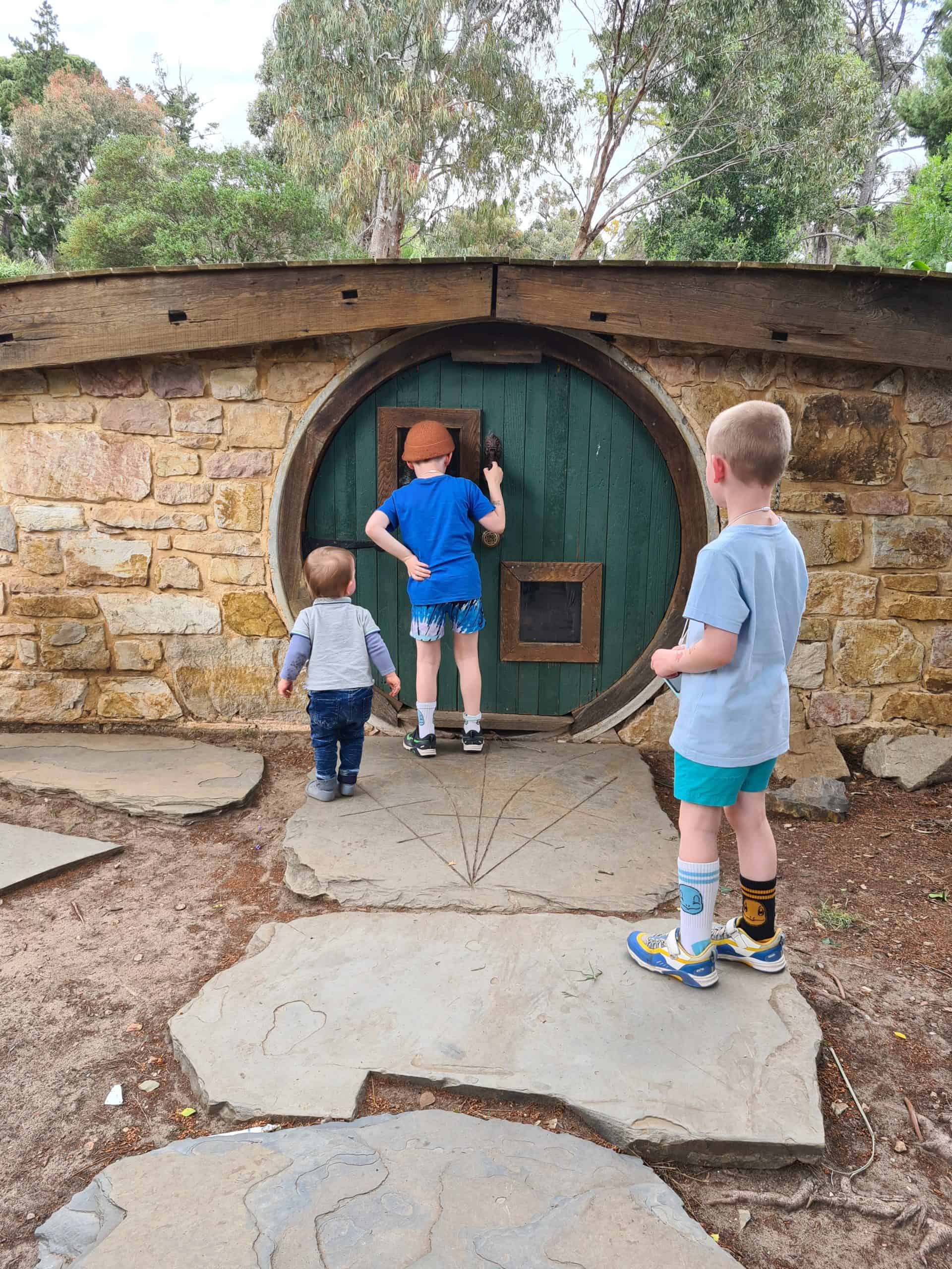 Little boy with sagittal synostosis with his siblings outdoors