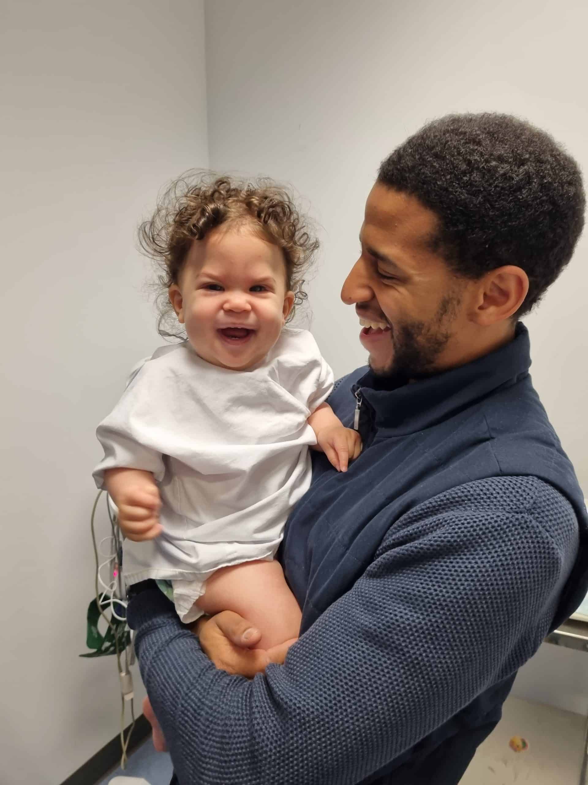 Girl with metopic synostosis held by her father