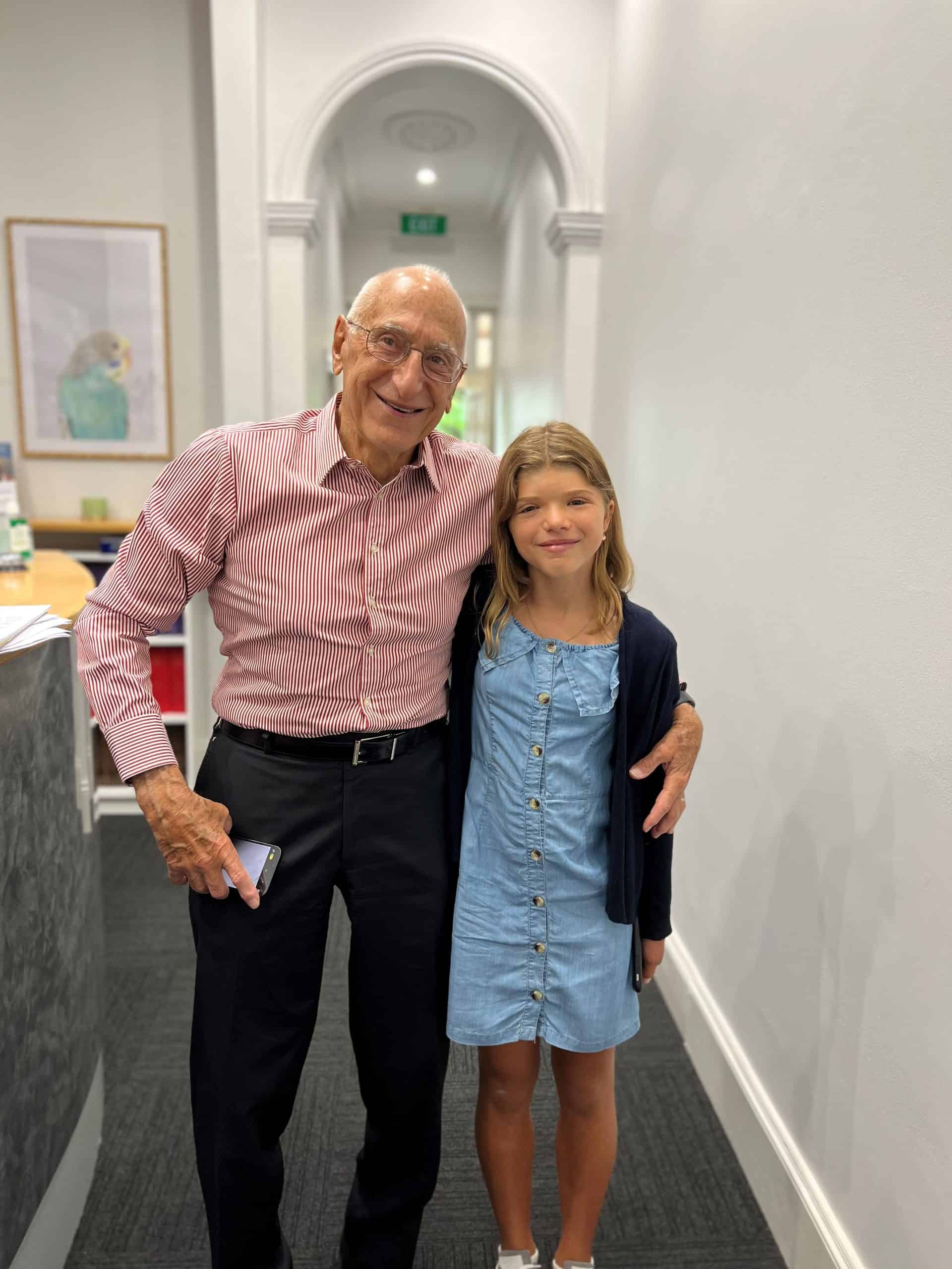 Prof David David and former patient with Seathre-Chotzen syndrome, standing together in Craniofacial Australia office.