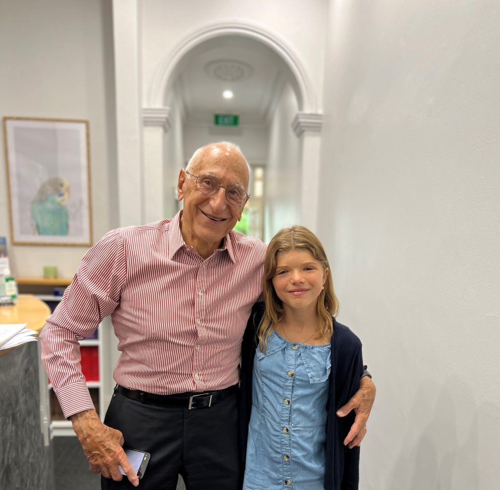 Prof David David and former patient with Seathre-Chotzen syndrome, standing together in Craniofacial Australia office.