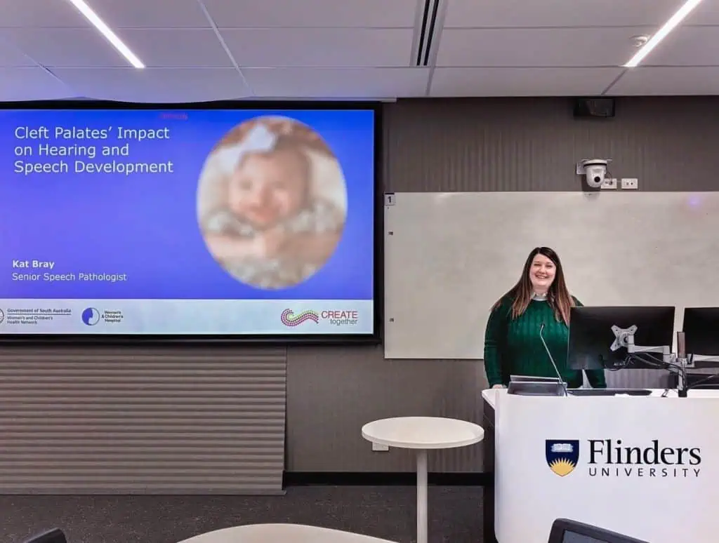 Speaker presenting on cleft palate's impact on speech at Flinders University.