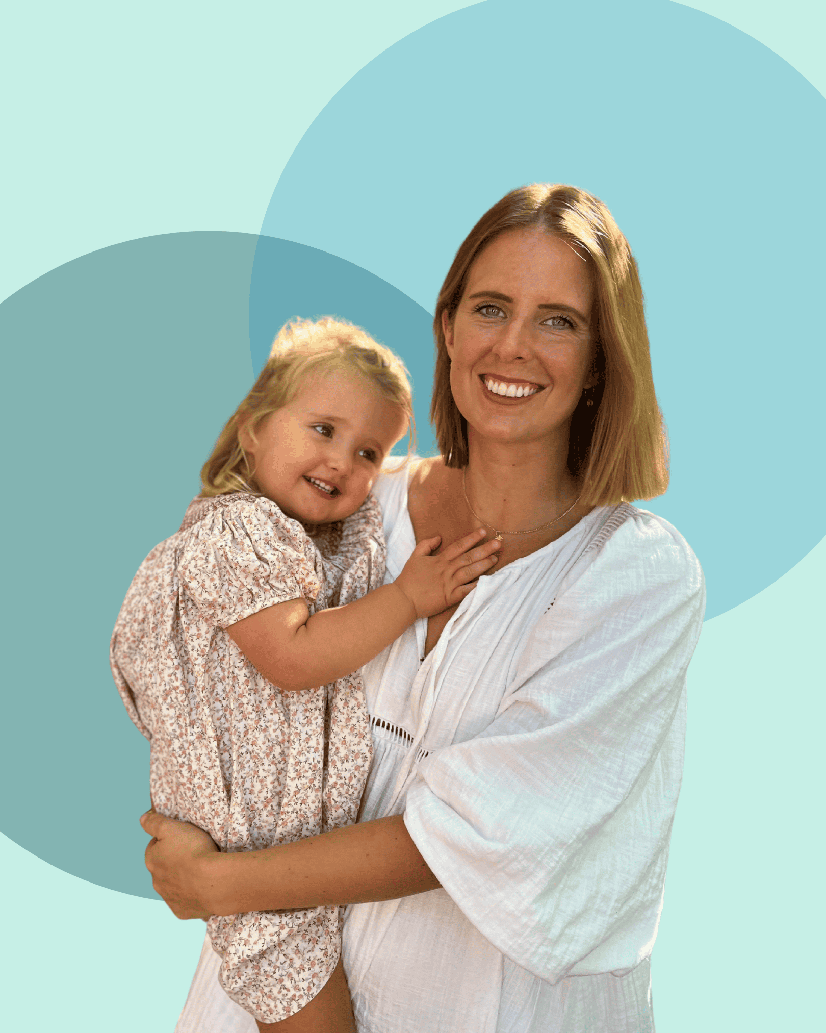 Smiling woman holding young girl in front of a pastel geometric background.