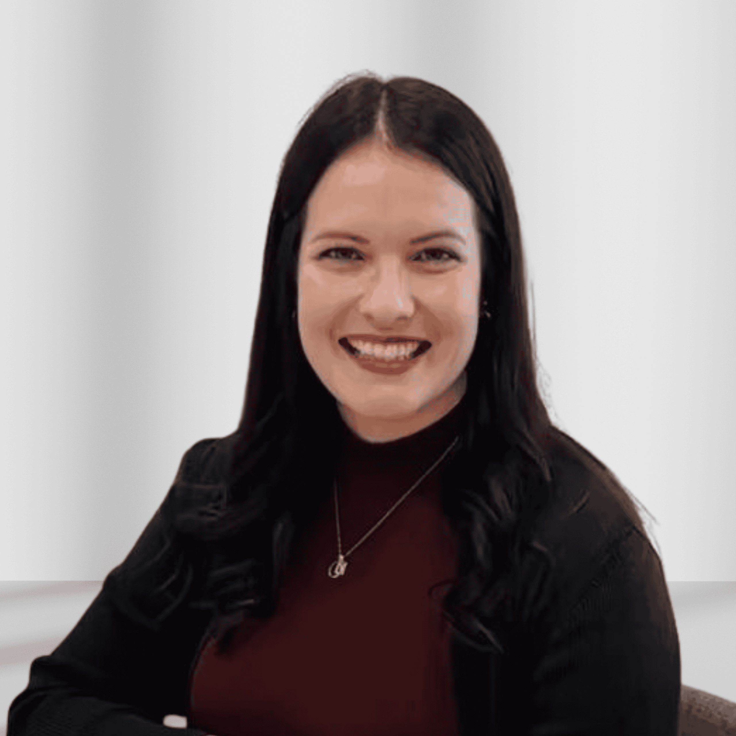 Smiling woman with dark hair in professional attire at Craniofacial Australia.